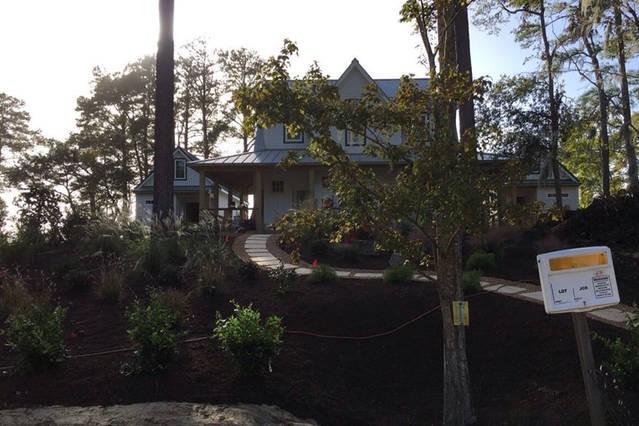 The WIE House is nestled on-top of a professionally landscaped soundfront lot. This is the view from parking lot. Stone walkway leads you up to main house.  Follow wrap-around porch to left to Pod Zeu